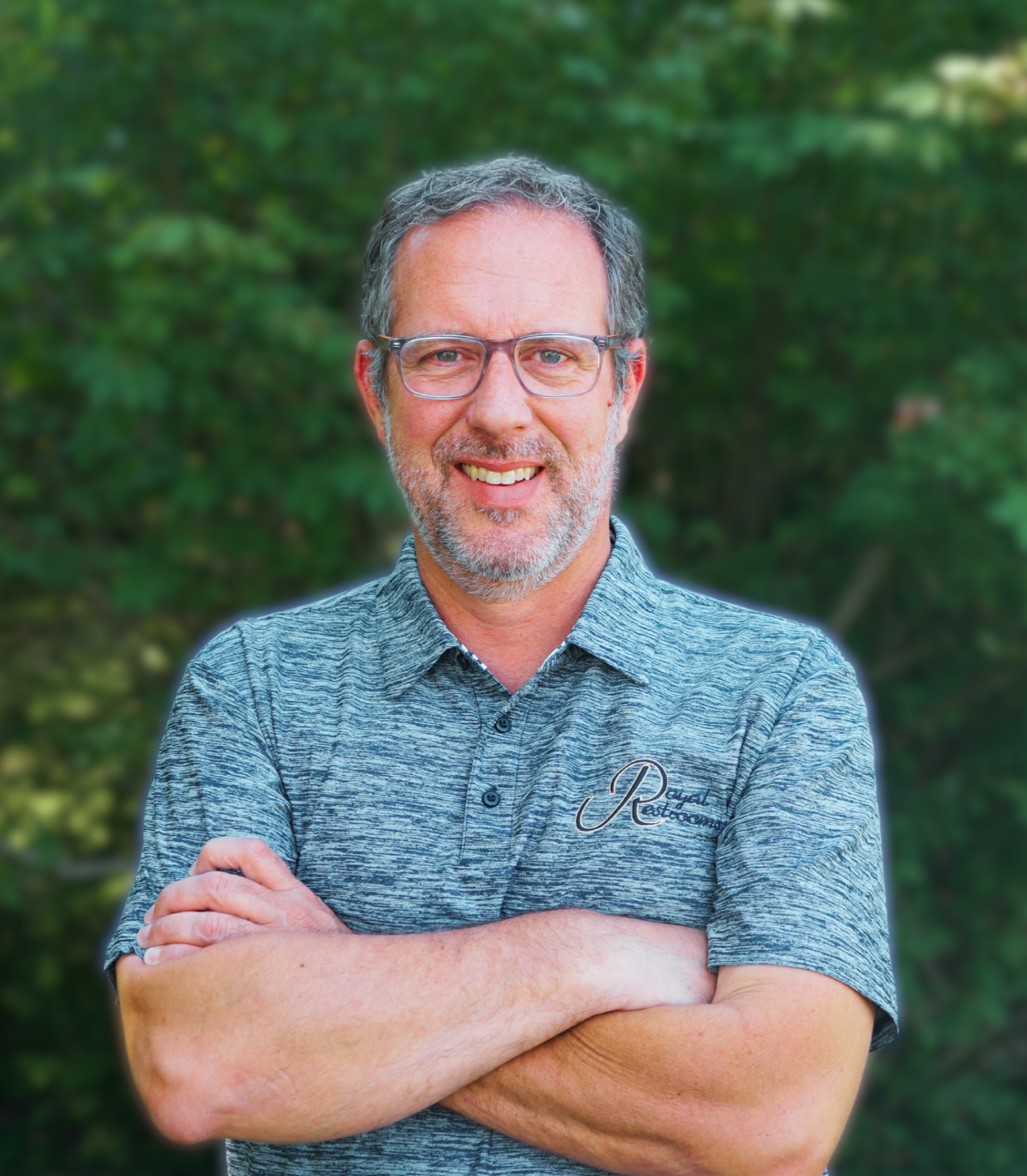 a man with glasses and a beard wearing a polo shirt